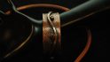 Copper Bracelet with Spirals Against a Wave